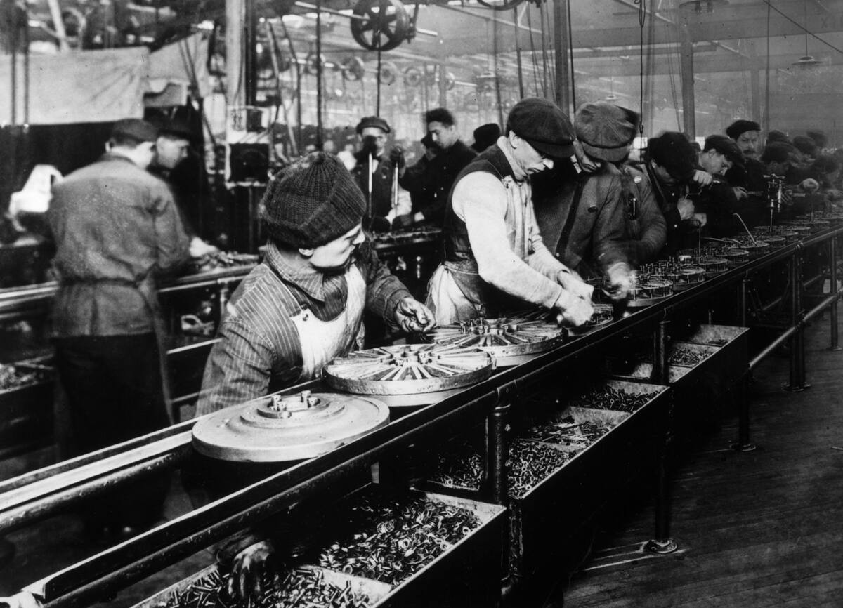 Workers on the first moving assembly line at Ford Highland Park plant, 1913